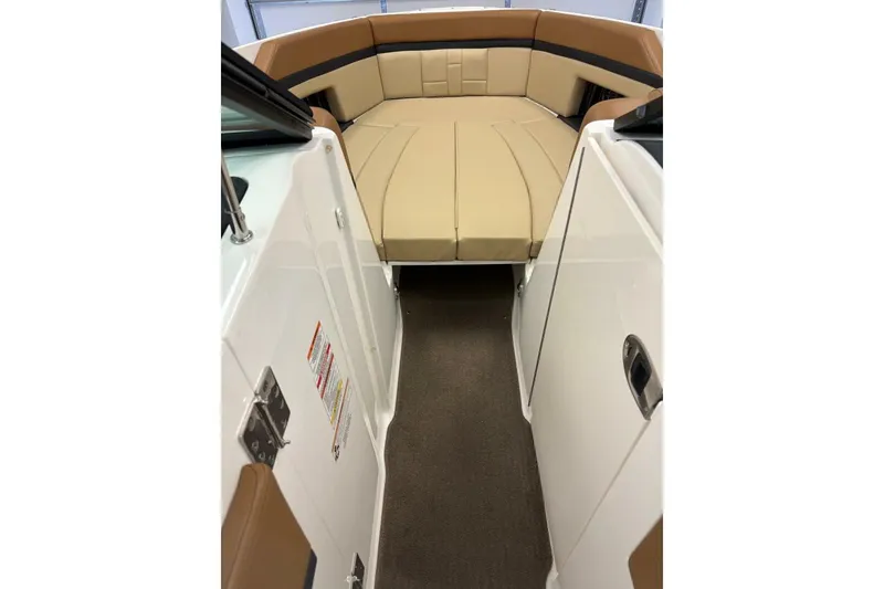 Slide: The Image of 2016 Sea Ray SLX 250 boat interior with tan seating and white panels. - 10