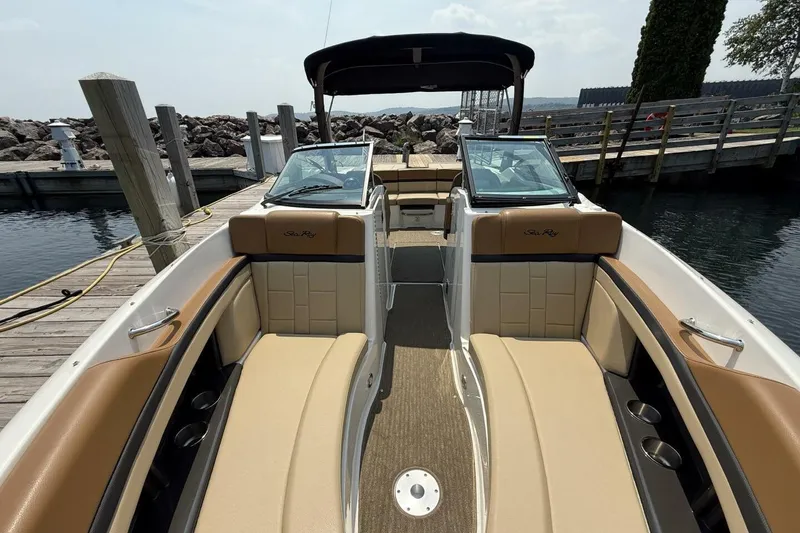 Slide: The Image of 2016 Sea Ray SLX 250 boat interior with tan seating at a dock. - 11