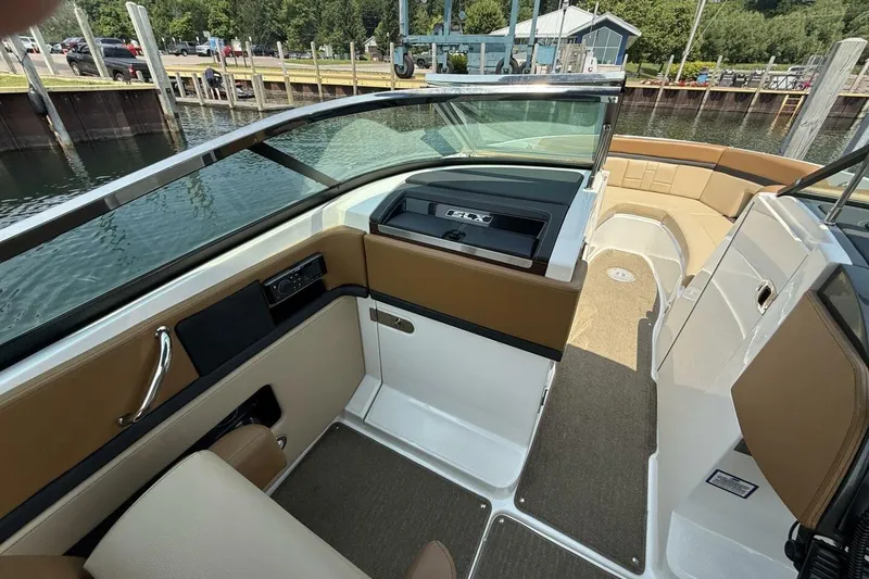 Slide: The Image of 2016 Sea Ray SLX 250 boat interior with tan seating and sleek design. - 13
