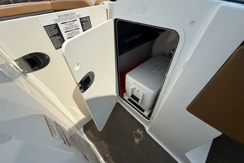 Slide: The Image of Storage compartment with cooler inside a 2016 Sea Ray SLX 250 boat. - 16