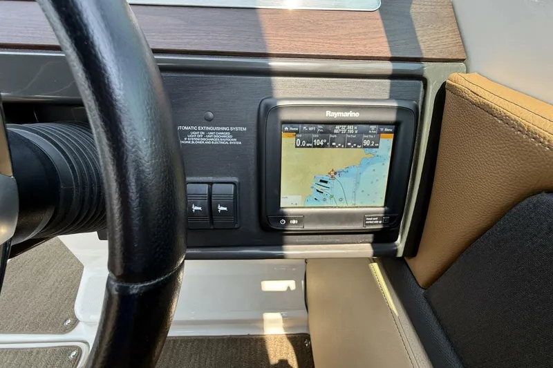 Slide: The Image of Steering wheel and navigation system of 2016 Sea Ray SLX 250 boat. - 18