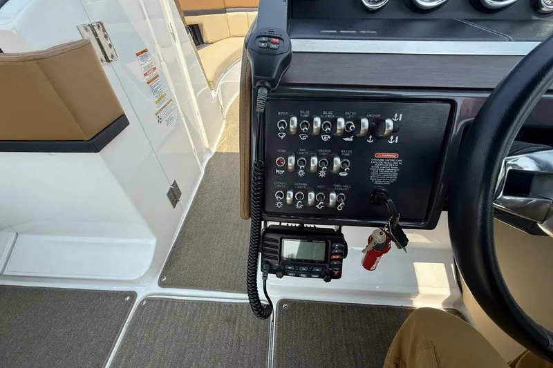 Slide: The Image of 2016 Sea Ray SLX 250 boat dashboard with control panel and radio. - 19