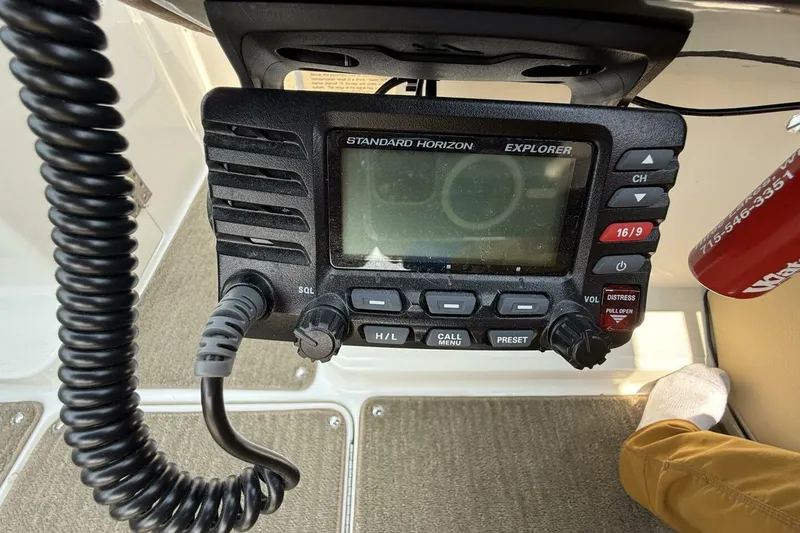 Slide: The Image of VHF radio on 2016 Sea Ray SLX 250 boat dashboard, featuring communication controls. - 20