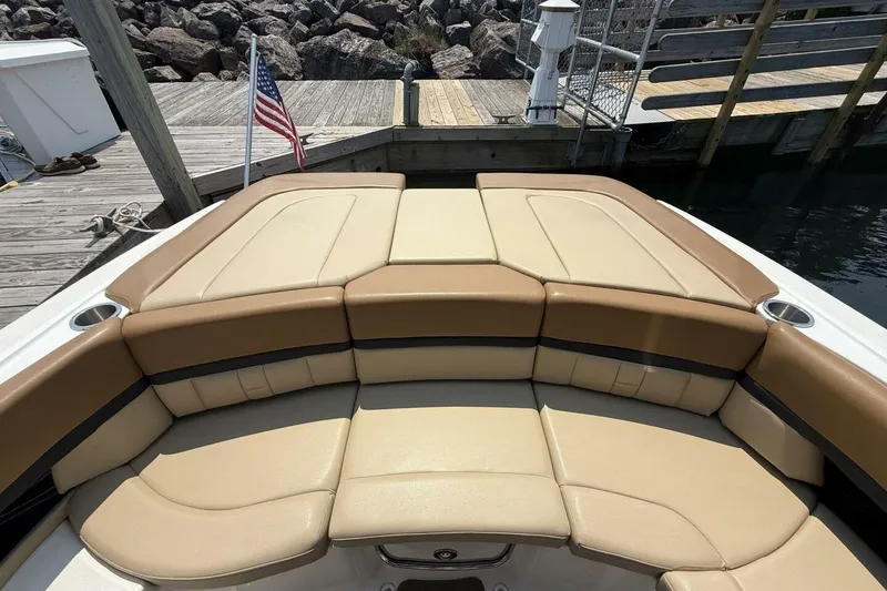 Slide: The Image of 2016 Sea Ray SLX 250 boat with tan seating at a dock. - 34