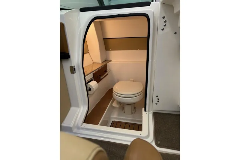 Slide: The Image of 2016 Sea Ray SLX 250 boat interior bathroom with toilet and storage. - 35