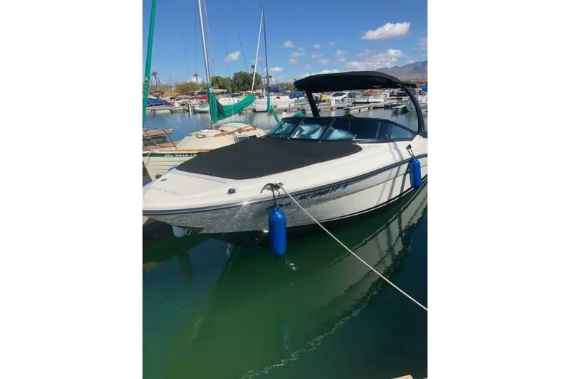 Slide: The Image of 2016 Sea Ray SLX 250 boat docked in a marina under a clear blue sky. - 45