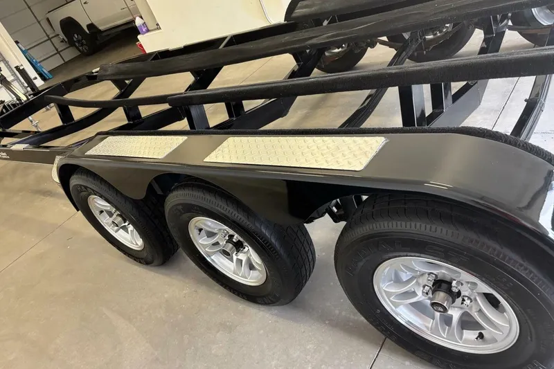 Slide: The Image of Triple-axle trailer for 2016 Sea Ray SLX 250 boat in a garage setting. - 48