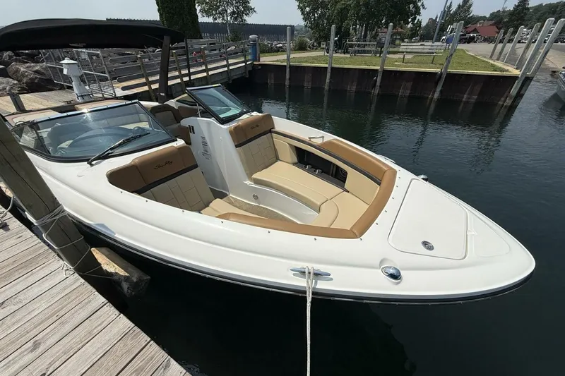 Slide: The Image of 2016 Sea Ray SLX 250 boat docked at a marina, featuring sleek design and spacious seating. - 5