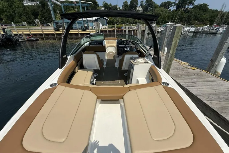 Slide: The Image of 2016 Sea Ray SLX 250 boat with spacious seating, docked at a marina. - 8