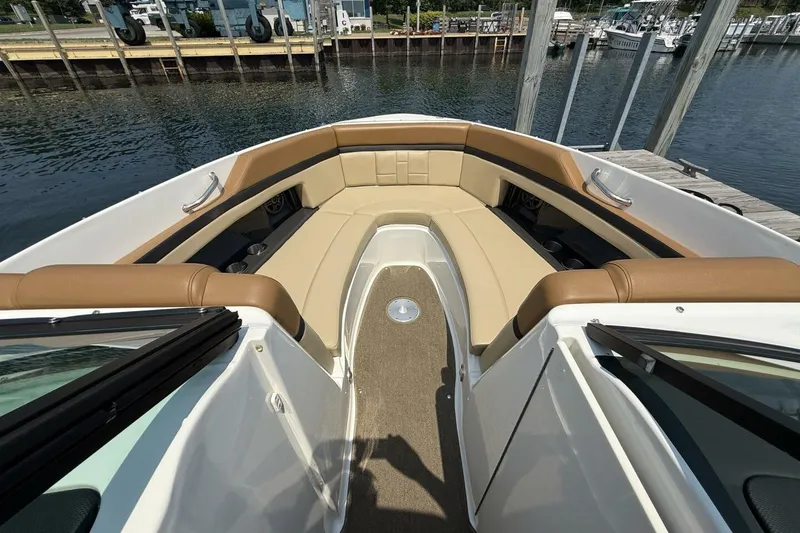 Slide: The Image of 2016 Sea Ray SLX 250 boat interior with tan seating and waterfront view. - 9