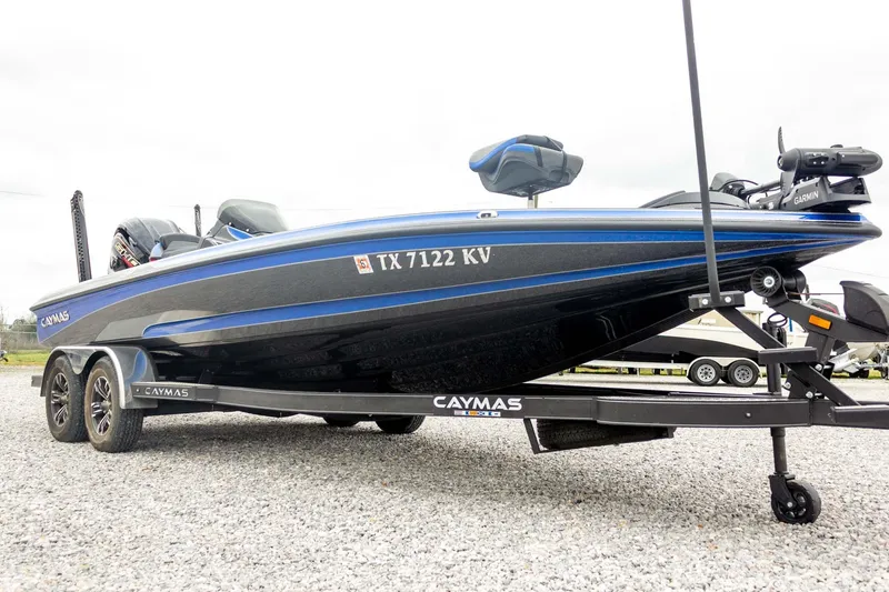 Slide: The Image of 2023 Caymas CX 21 PRO boat on trailer, side view, blue and black design. - 11