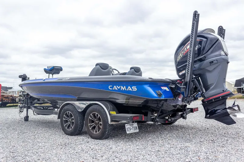 Slide: The Image of 2023 Caymas CX 21 PRO boat with Yamaha engine on a trailer, parked on gravel. - 15