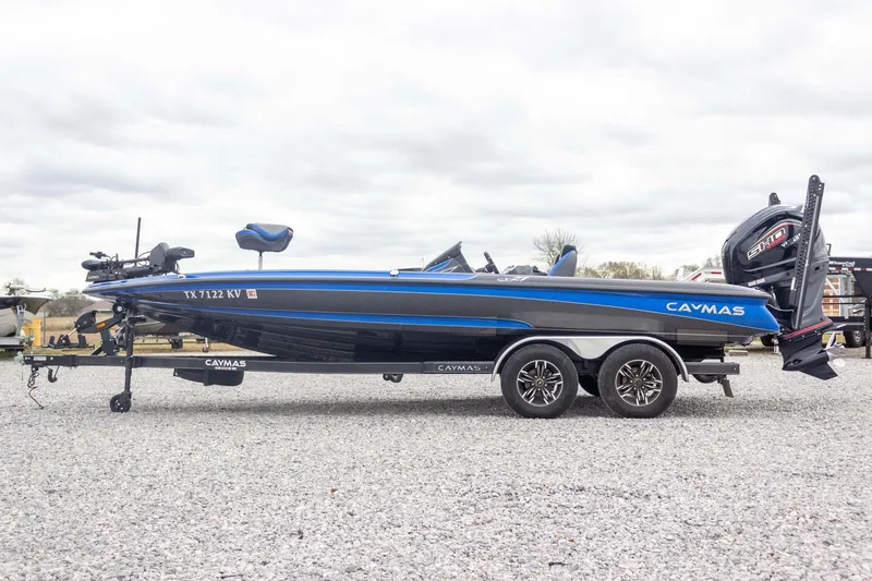 Slide: The Image of 2023 Caymas CX 21 PRO boat on trailer, side view, blue and black design. - 16