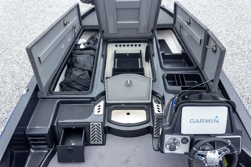 Slide: The Image of 2023 Caymas CX 21 PRO boat interior with storage compartments and Garmin navigation system. - 30