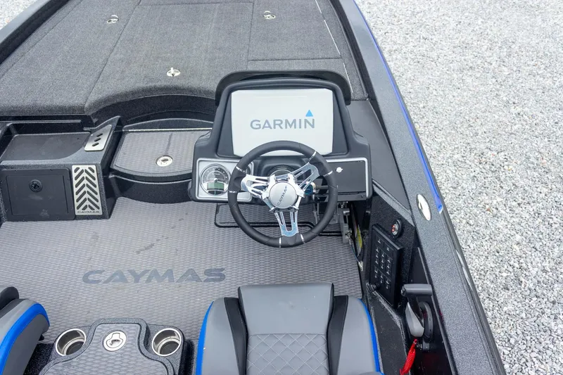 Slide: The Image of 2023 Caymas CX 21 PRO boat dashboard with Garmin display and steering wheel. - 36
