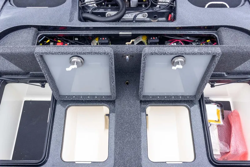 Slide: The Image of 2023 Caymas CX 21 PRO boat storage compartments with open hatches and visible wiring. - 44