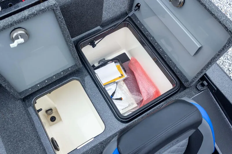 Slide: The Image of 2023 Caymas CX 21 PRO boat storage compartments with open lids and visible contents. - 46