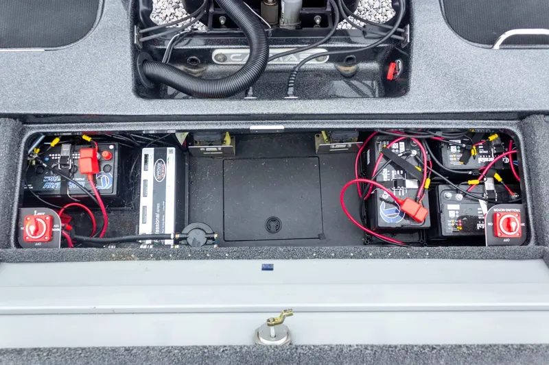 Slide: The Image of 2023 Caymas CX 21 PRO boat battery compartment with wiring and switches. - 48