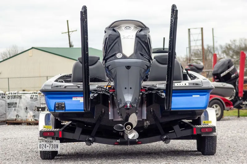 Slide: The Image of 2023 Caymas CX 21 PRO boat on trailer, rear view with powerful outboard motor. - 7