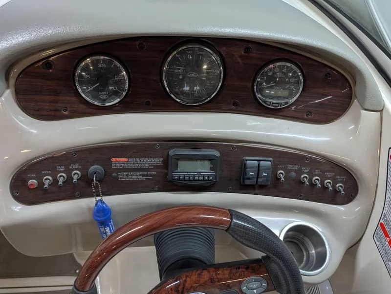 Slide: The Image of Dashboard of a 2006 Sea Ray 270 Sundeck boat with wood paneling. - 16