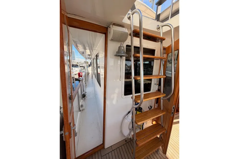 Slide: The Image of 1984 Hartman-Palmer 60 Flush Deck Motor Yacht with wooden ladder and deck view. - 10