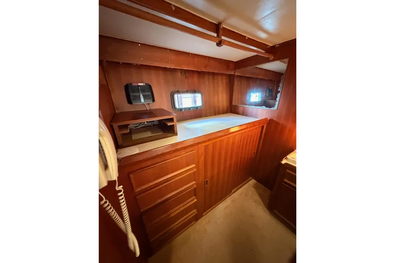Slide: The Image of Interior of 1984 Hartman-Palmer 60 Flush Deck Motor Yacht with wood paneling and porthole windows. - 100