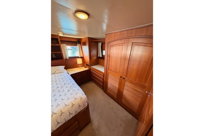 Slide: The Image of Luxurious 1984 Hartman-Palmer yacht bedroom with wooden cabinetry and cozy decor. - 109