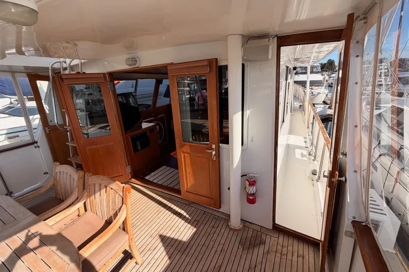 Slide: The Image of 1984 Hartman-Palmer 60 Flush Deck Motor Yacht interior with wooden doors and seating area. - 11