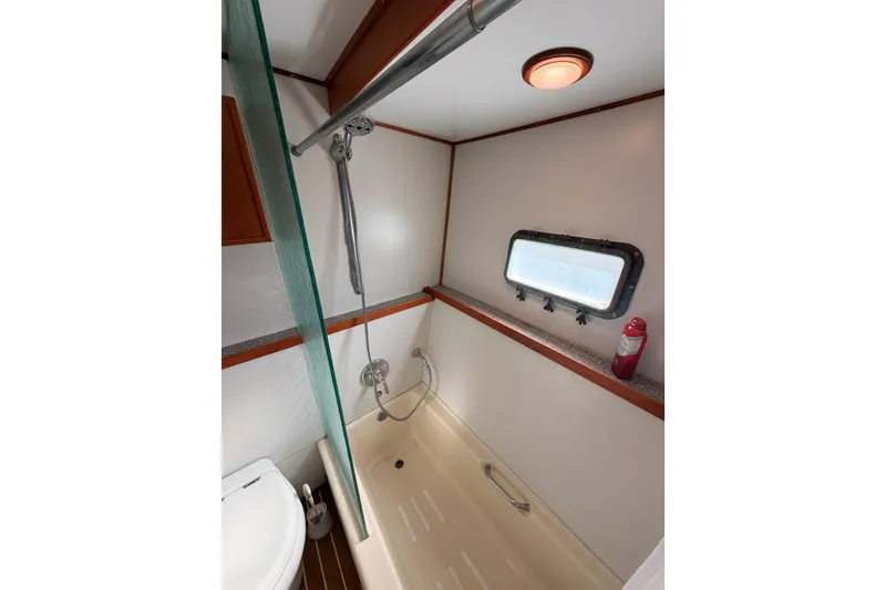 Slide: The Image of Bathroom interior of 1984 Hartman-Palmer 60 Flush Deck Motor Yacht, featuring shower and porthole. - 112