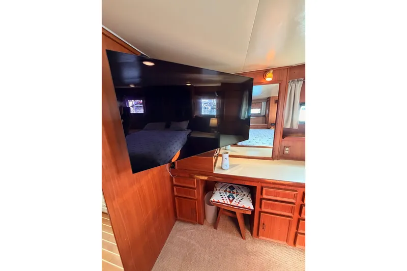 Slide: The Image of Interior of 1984 Hartman-Palmer 60 Flush Deck Motor Yacht with TV and wooden cabinetry. - 115