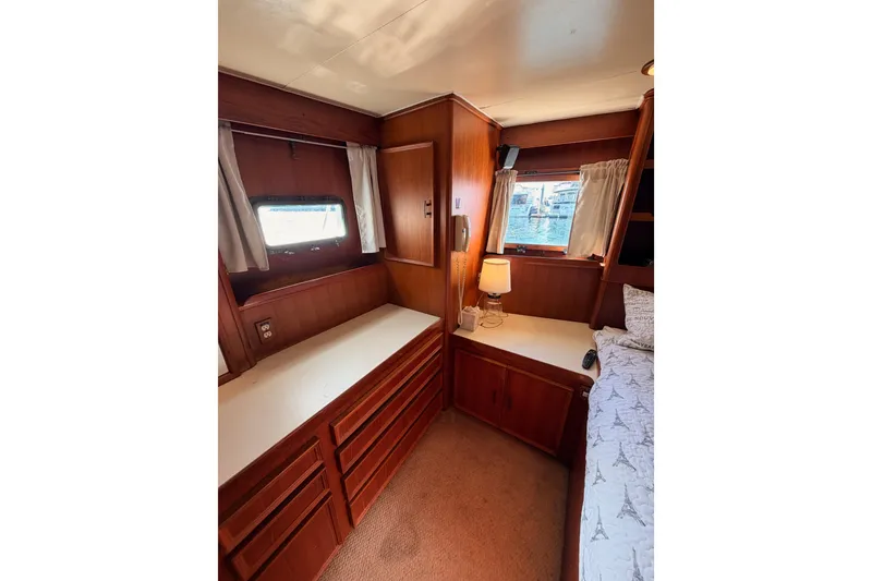 Slide: The Image of Interior of 1984 Hartman-Palmer 60 Flush Deck Motor Yacht, featuring wood cabinetry and cozy decor. - 116