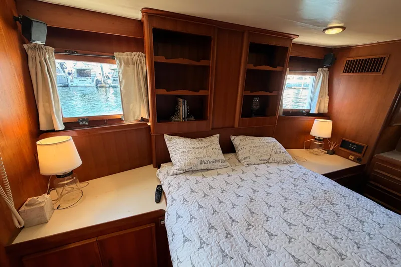 Slide: The Image of Cozy bedroom in 1984 Hartman-Palmer 60 Flush Deck Motor Yacht with wood paneling. - 117