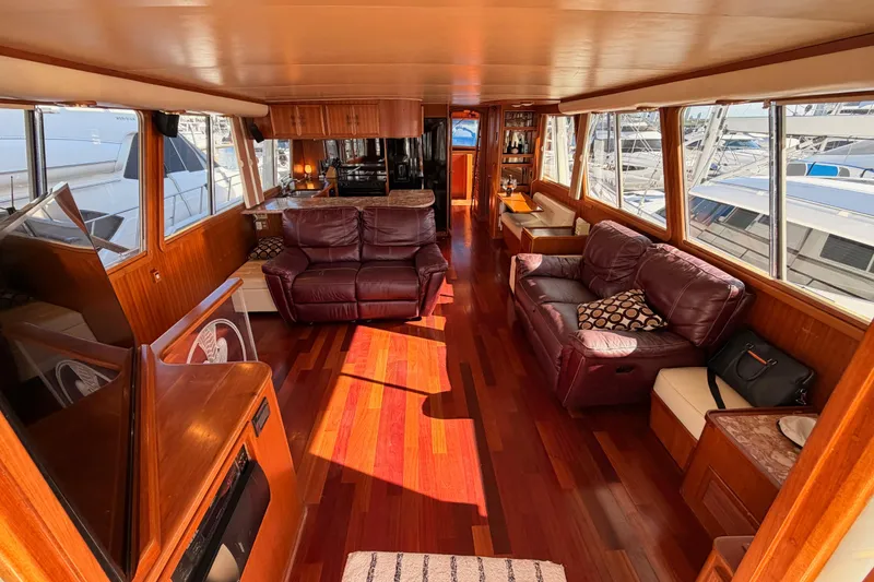Slide: The Image of Luxurious interior of 1984 Hartman-Palmer 60 Flush Deck Motor Yacht with leather seating and wood flooring. - 12