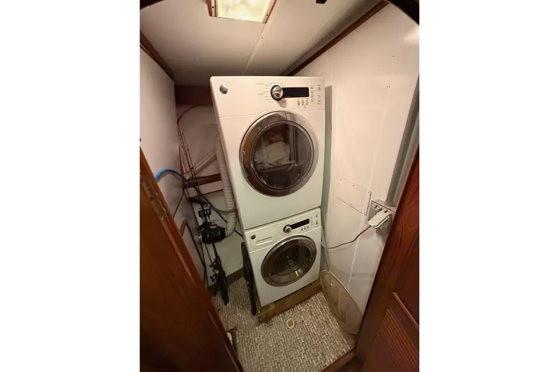 Slide: The Image of Laundry area with stacked washer and dryer on 1984 Hartman-Palmer 60 Flush Deck Motor Yacht. - 125