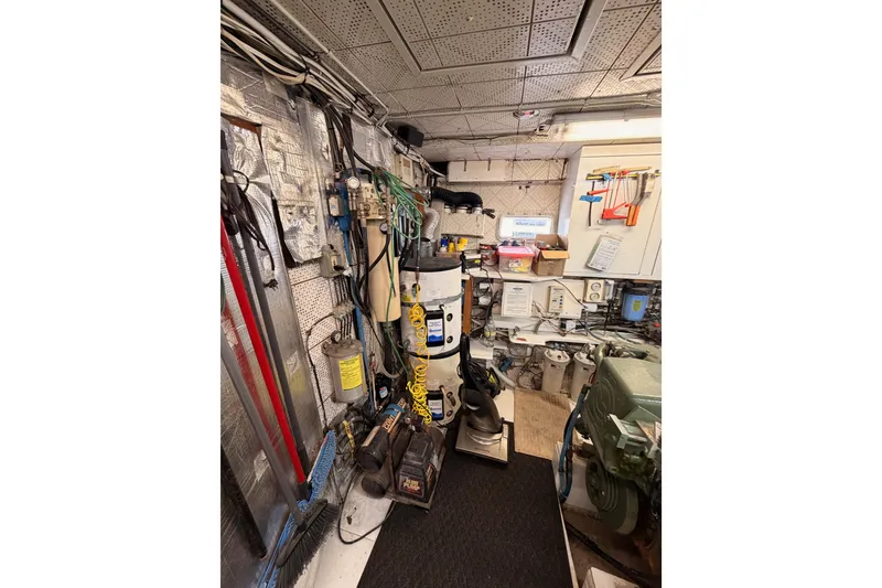 Slide: The Image of Engine room of 1984 Hartman-Palmer 60 Flush Deck Motor Yacht, featuring equipment and tools. - 129