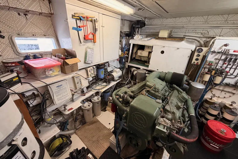 Slide: The Image of Engine room of a 1984 Hartman-Palmer 60 Flush Deck Motor Yacht, featuring tools and equipment. - 130