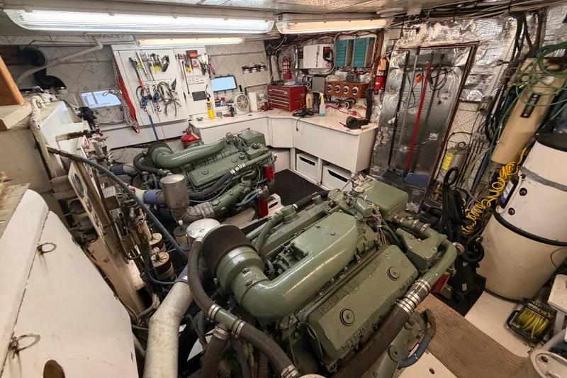 Slide: The Image of Engine room of a 1984 Hartman-Palmer 60 Flush Deck Motor Yacht, featuring dual engines. - 133