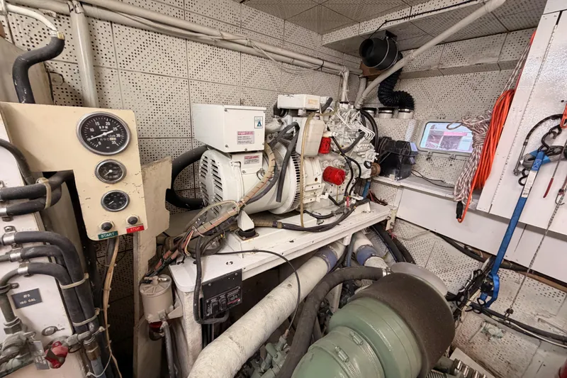 Slide: The Image of Engine room of 1984 Hartman-Palmer 60 Flush Deck Motor Yacht, featuring machinery and control panel. - 135