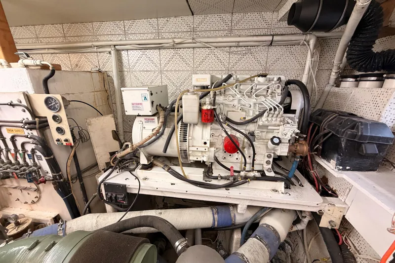 Slide: The Image of Engine room of 1984 Hartman-Palmer 60 Flush Deck Motor Yacht, showcasing machinery and wiring. - 138