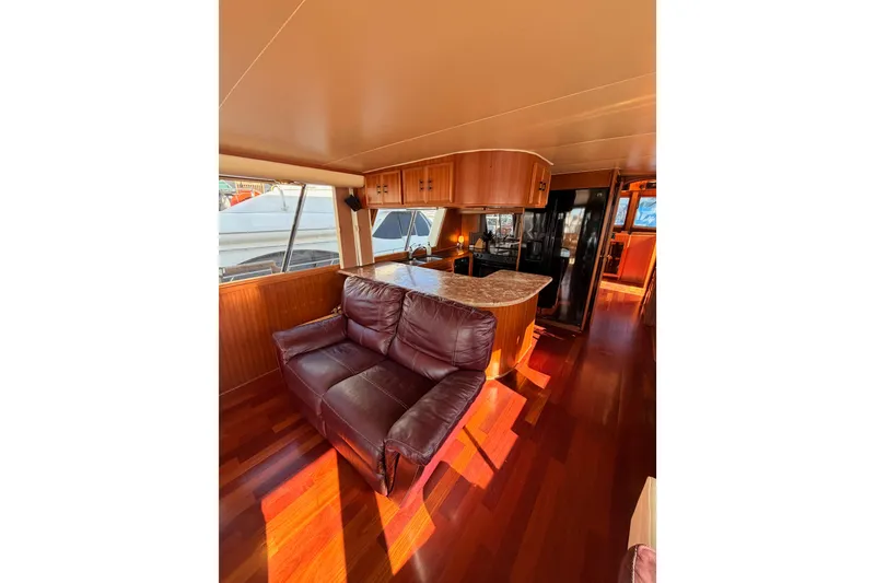 Slide: The Image of Interior of 1984 Hartman-Palmer 60 Flush Deck Motor Yacht with leather sofa and wooden cabinetry. - 16