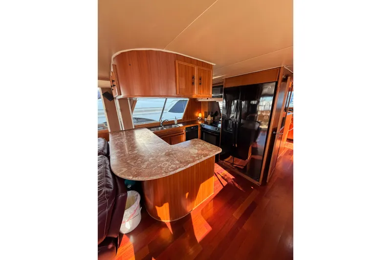 Slide: The Image of Interior of 1984 Hartman-Palmer 60 Flush Deck Motor Yacht with wood finishes and modern kitchen. - 18
