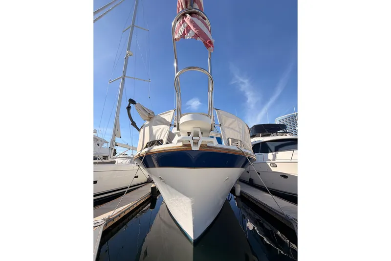 Slide: The Image of 1984 Hartman-Palmer 60 Flush Deck Motor Yacht docked under clear blue sky. - 2
