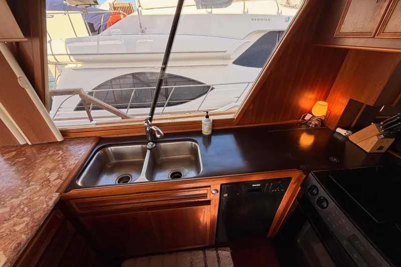 Slide: The Image of Interior of 1984 Hartman-Palmer yacht kitchen with sink, countertop, and window view. - 22