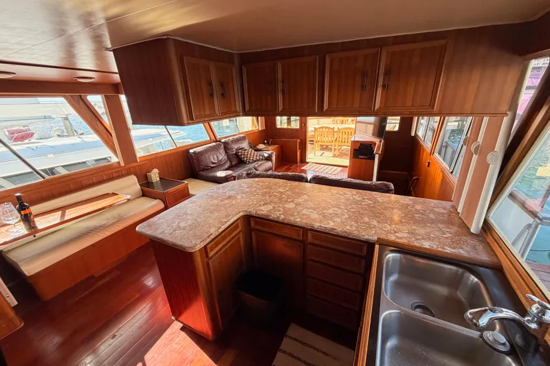 Slide: The Image of Interior of 1984 Hartman-Palmer 60 Flush Deck Motor Yacht with wood finishes and seating area. - 23