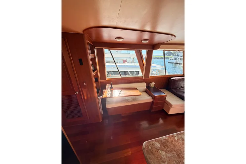 Slide: The Image of Interior of 1984 Hartman-Palmer 60 Flush Deck Motor Yacht with wood finish and waterfront view. - 24