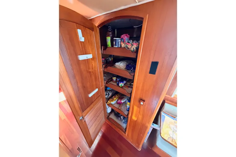 Slide: The Image of Wooden pantry shelves inside 1984 Hartman-Palmer 60 Flush Deck Motor Yacht. - 26