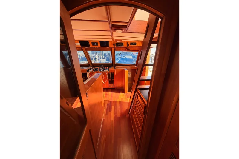 Slide: The Image of Interior view of 1984 Hartman-Palmer 60 Flush Deck Motor Yacht, featuring wooden finishes and helm. - 27