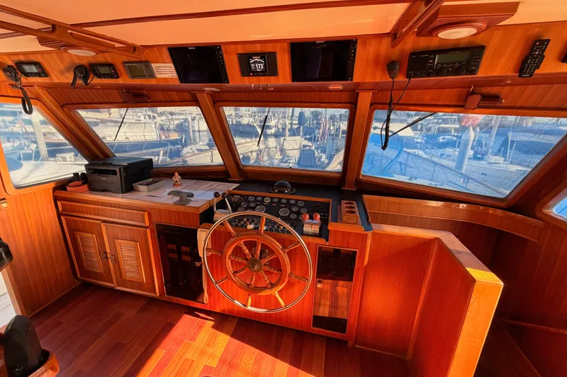 Slide: The Image of 1984 Hartman-Palmer 60 Flush Deck Motor Yacht helm with wooden interior and navigation equipment. - 29
