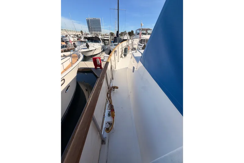 Slide: The Image of 1984 Hartman-Palmer 60 Flush Deck Motor Yacht docked in marina, side view. - 32