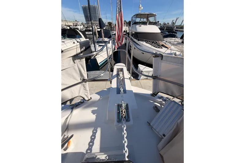 Slide: The Image of 1984 Hartman-Palmer 60 Flush Deck Motor Yacht docked at marina, view from bow. - 34